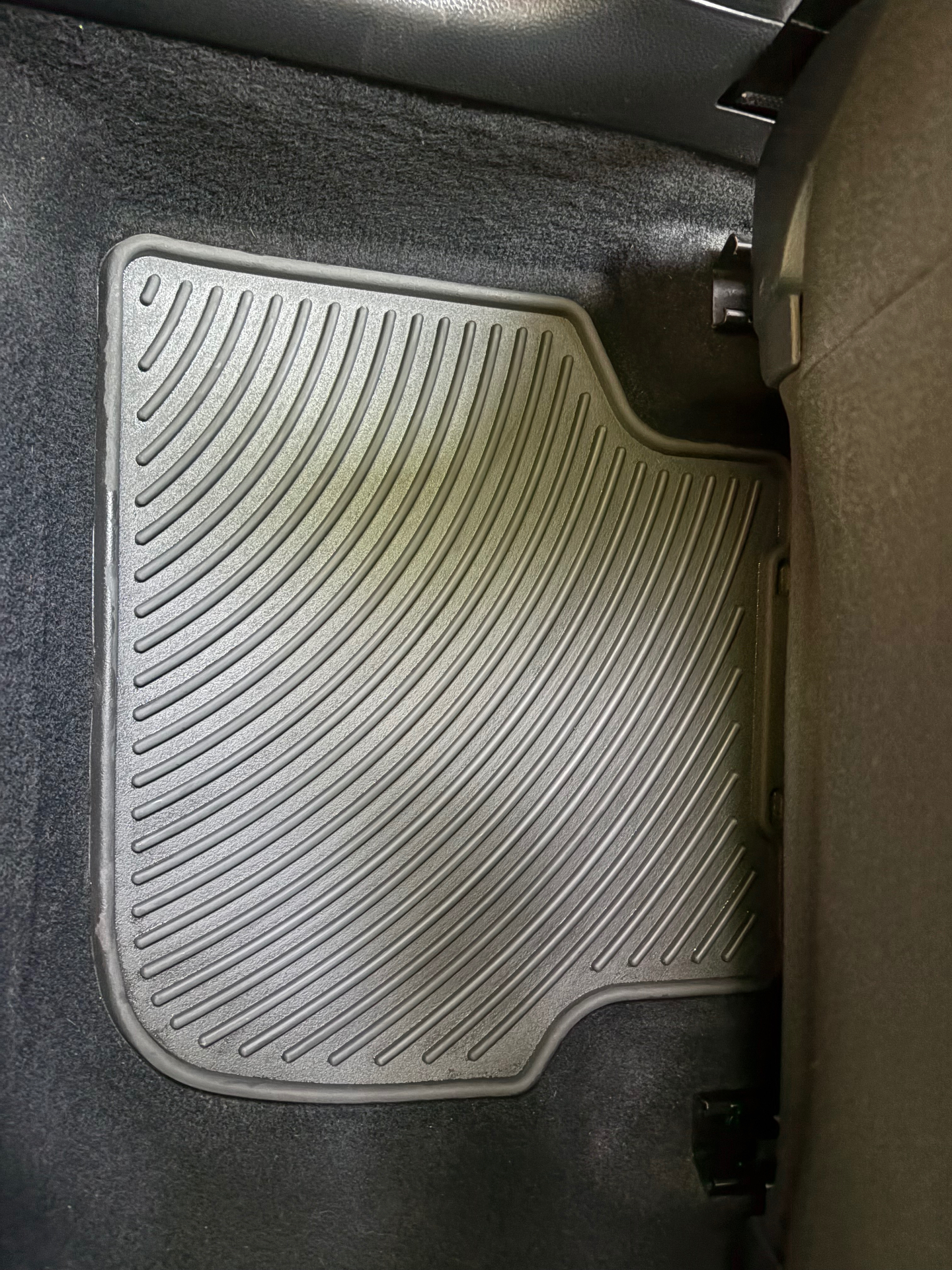 Car floor mat after detailing — spotless rubber finish